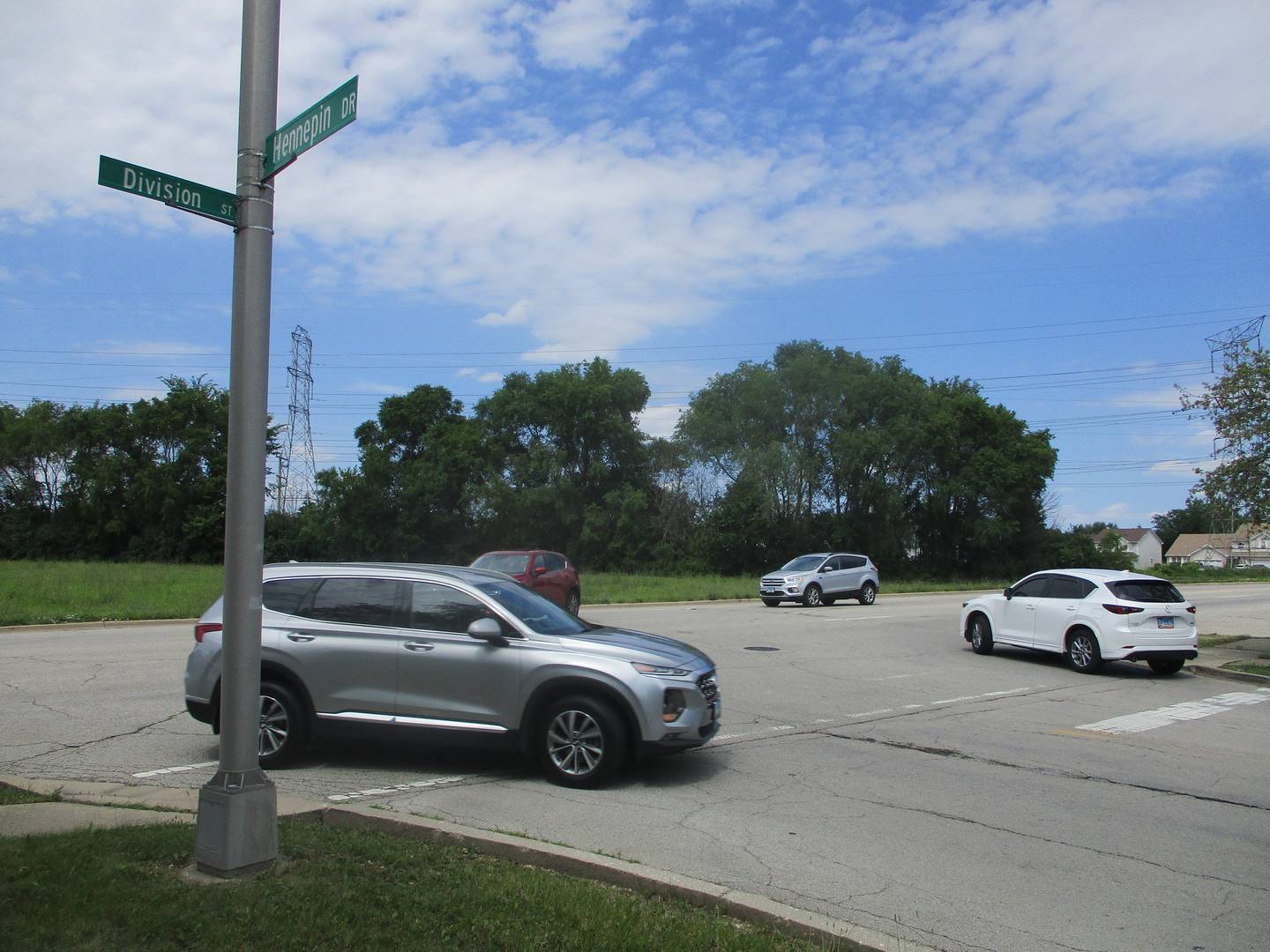 Traffic moves on and off Division Street at a Hennepin Drive intersection that is across from the Joliet site where MWI Property Group wants to develop a warehouse and possible assembly plant. June 24, 2024