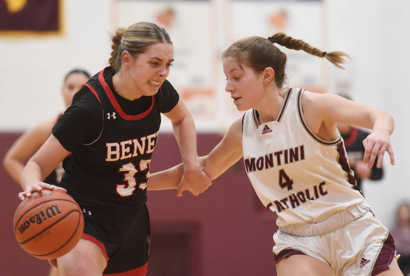 Benet Academy’s Magdalena Sularski, left, drives to the basket against Montini’s Riley White during the semifinal of the Montini girls basketball tournament Thursday December 28, 2023 in Lombard.