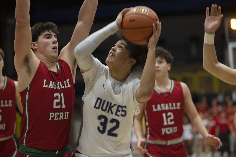 Dixon’s Darius Harrington workjs against LaSalle-Peru’s Josh Senica Wednesday, Feb. 21, 2024 at the Sterling class 3A basketball regional.