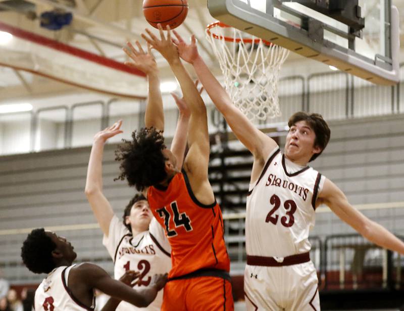 Antioch’s Carter Webb tries to block the shot of McHenry's Adam Anwar during a nonconference basketball game Thursday, Jan. 4. 2024, at Antioch High School.