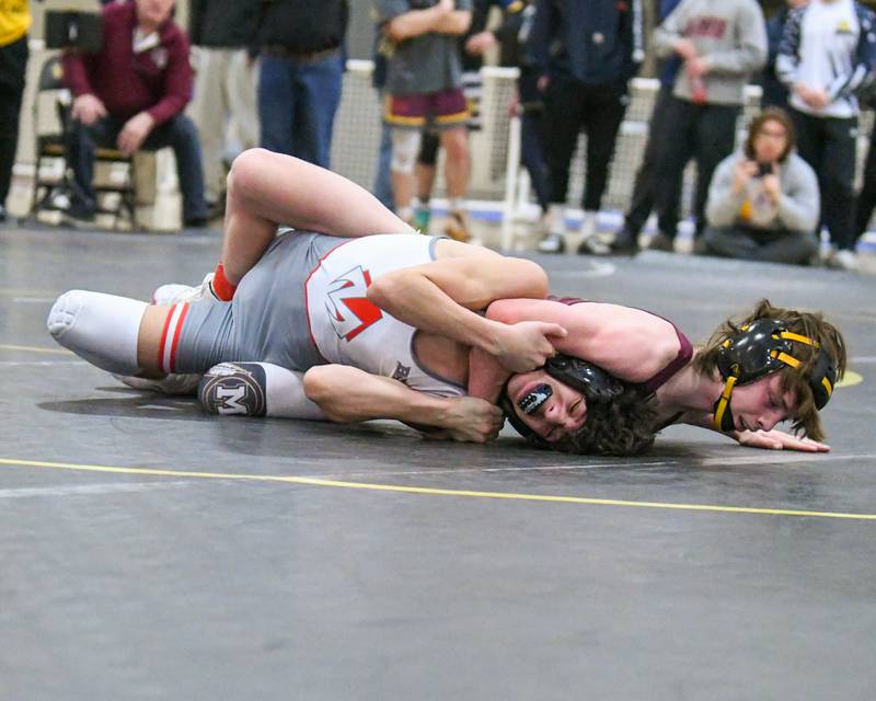 Morris wrestler Owen sater, right, wrestles in the 106 weight class against Morton Noah Harris during the 2A sectional meet held at Sycamore High School on Saturday Feb. 10, 2024.