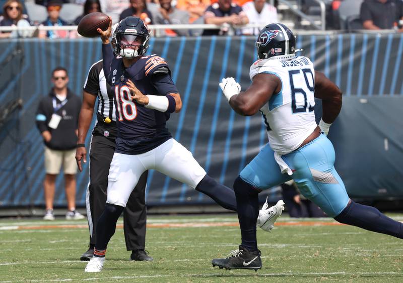 Chicago Bears quarterback Caleb Williams throws a pass avoiding the pressure of Tennessee Titans defensive tackle Sebastian Joseph-Day during their game Sunday, Sept. 8, 2024, at Soldier Field in Chicago.