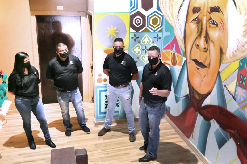 Co-owners Olivia Pacheco, (L-R) Rudy Hernandez, Christopher Cardenas and Ryan Gifford talk about their new restaurant Thursday, El Jimador Mexican Grill, 260 E. Lincoln Highway in DeKalb. The mural in the background was painted by Sycamore artist Brett Whitacre and depicts Rudy Hernandez's grandfather, Tomas Sanches, a jimador, which is is someone that harvests the agave plant. The restaurant is planning to open in the last weekend in September.