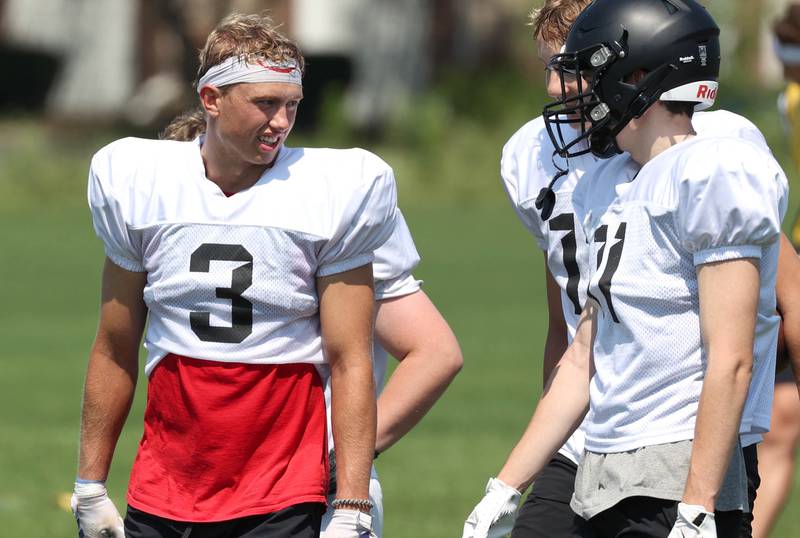 Sycamore’s Carter York (left) talks to teammates during a break Monday, July 15, 2024, at summer football camp at Sycamore High School.