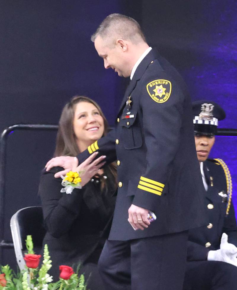 DeKalb County Sheriff Andy Sullivan is greeted by Bridgette Caporaso sister of the late DeKalb County Sheriff’s Deputy Christina Musil after he spoke about his colleague Thursday, April 4, 2024, during her visitation and funeral in the Convocation Center at Northern Illinois University. Musil, 35, was killed March 28 while on duty after a truck rear-ended her police vehicle in Waterman.