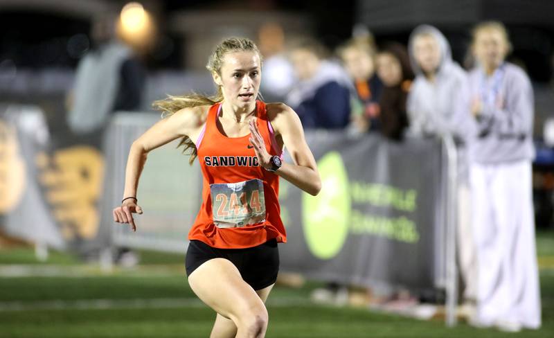 Sundara Weber of Sandwich wins the varsity girls race during the Naperville North Twilight Cross Country Invitational on Wednesday, Oct. 9, 2024 in Naperville.