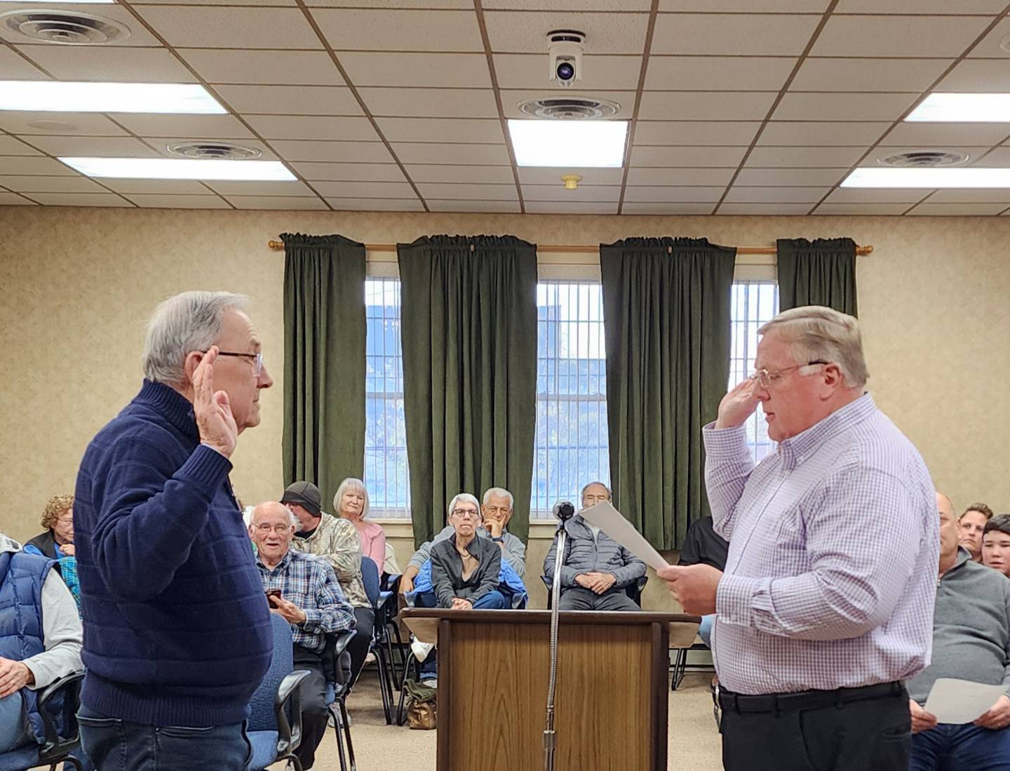 Princeton Council Member Jerry Neumann delivers the oath of office to City Clerk Peter Nelson during the Monday, May 1, 2023 city council meeting.