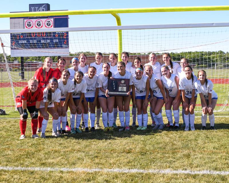St. Charles North poses with the sectional championship plaque after taking the win over Wheaton North on Saturday May 25, 2024, held at South Elgin High School.