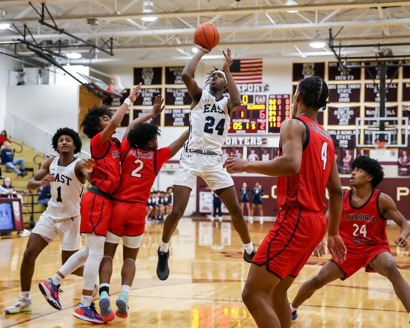 Oswego East's Mekhi Lowery (24) shoots a jump shot during Class 4A Lockport Regional final game between West Aurora at Oswego East.  Feb 24, 2023.