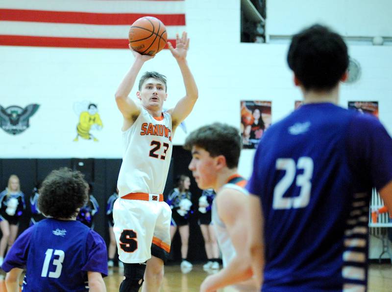 Sandwich's Chance Lange (23) takes a long jump shot over the Plano defense during a varsity basketball game at Sandwich High School on Tuesday, Feb. 13, 2024.