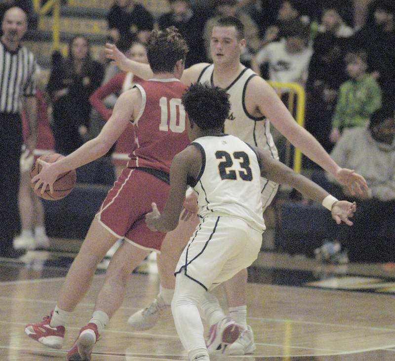 Ottawa's Evan Snook is met by Sterling's Lucas Austin while being pursued by Kaedon Phillips during Sterling’s 3A Regional semifinal game Wednesday, Feb. 21, 2024, at Sterling High School.