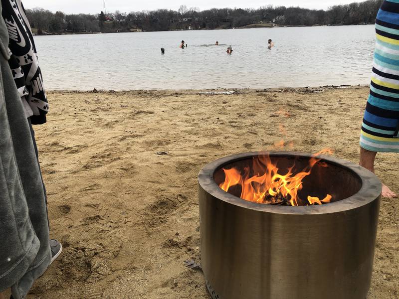 Five of the 20 people at Oakwood Hill's Silver Lake on Monday, Jan. 1, 2024, for the third-annul New Year's Day Swim braved the icy water for just over three minutes.