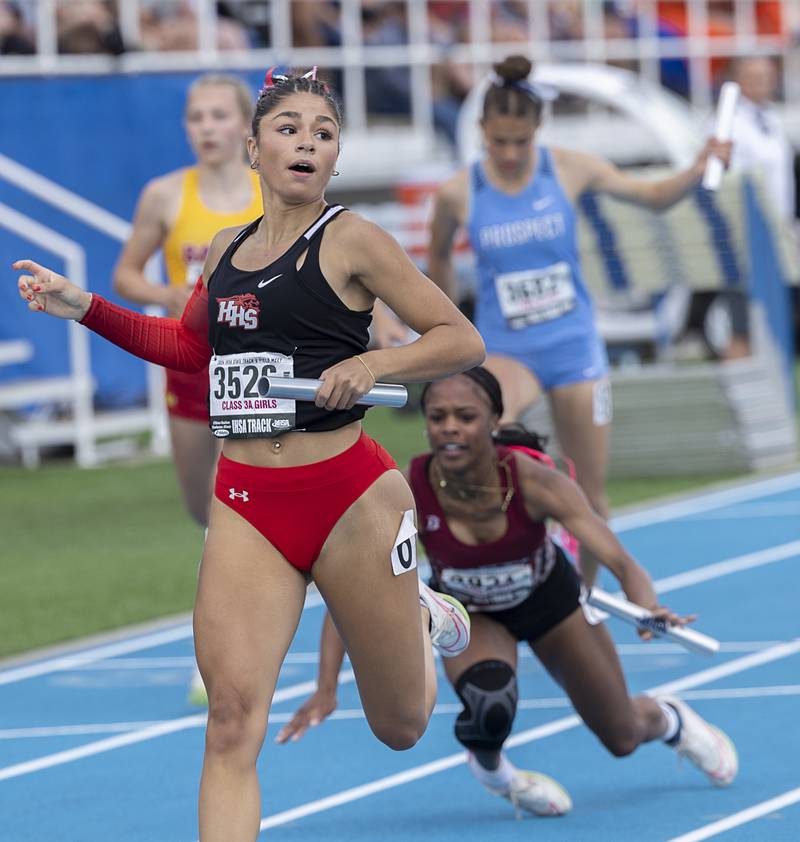 Huntley’s Victoria Evtimov looks for her teams time in the 3A 4x100 Saturday, May 18, 2024 at the IHSA girls state track meet in Charleston.