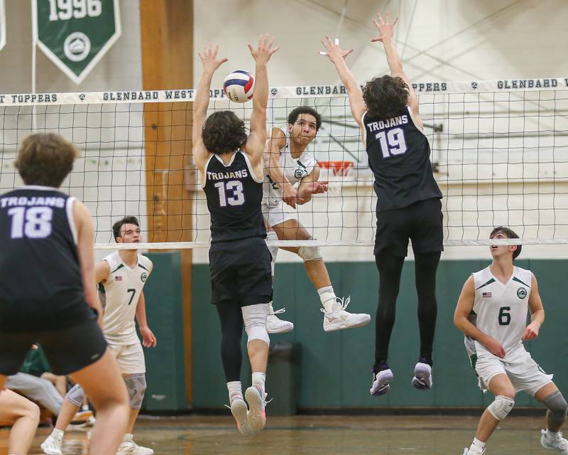 Glenbard West's Xzavion Willett (22) has his shot blokced during volleyball match between Downers Grove North at Glenbard West.  April 2, 2024.