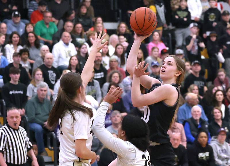 Kaneland's Sam Kerry shoots over a pair of Sycamore defenders during their Class 3A sectional semifinal Tuesday, Feb. 20, 2024, at Sycamore High School.