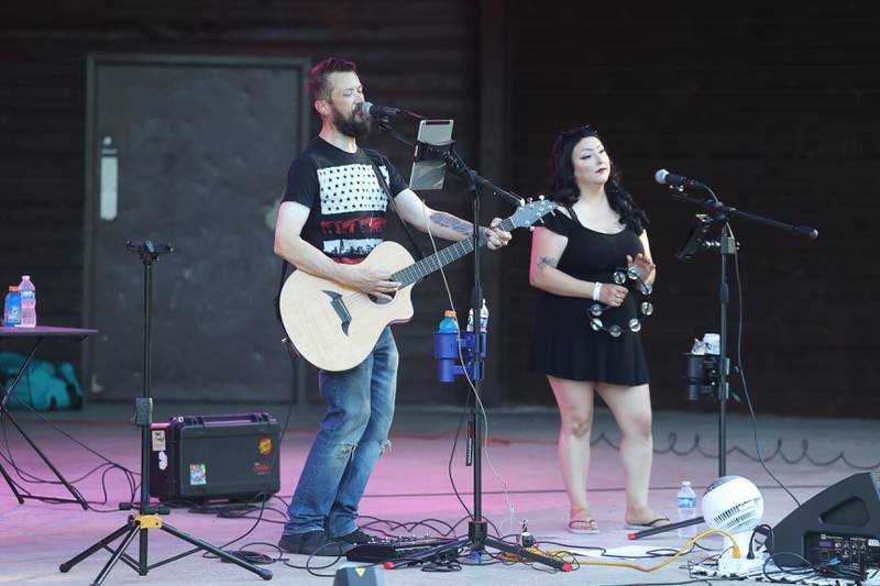 Chris and Bri Moran perform before the start of the fireworks at Dellwood Park in Lockport on Wednesday July 3, 2024.