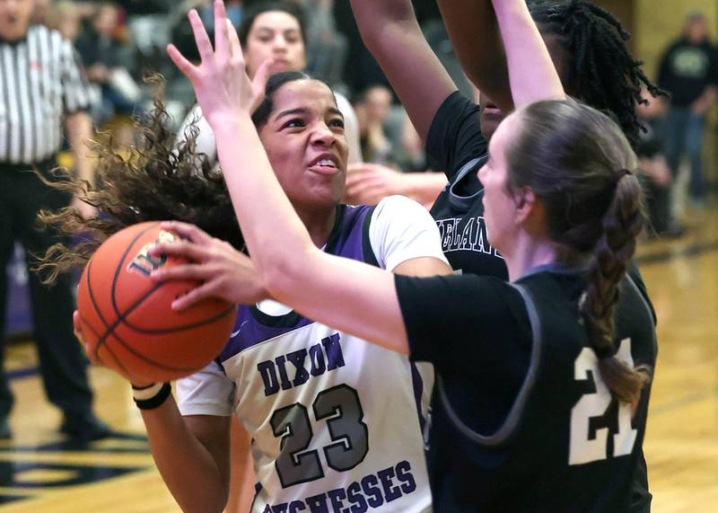 Dixon’s Ahmyrie McGowan is guarded by Kaneland's Kyra Lilly (front) and Amani Meeks Thursday, Feb. 22, 2024, during their Class 3A sectional final game at Sycamore High School.