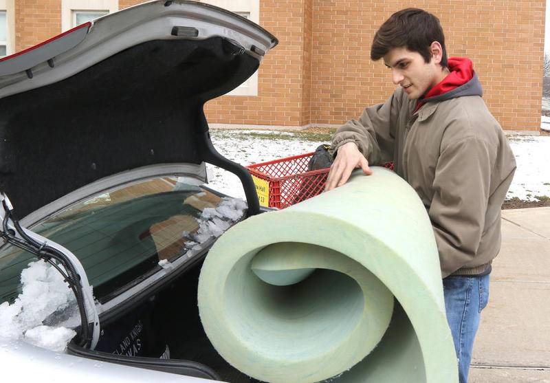 Northern Illinois University junior Adam Rivas, from Sugar Grove, moves out of his dorm on campus at New Hall East March 23 as NIU has halted face-to-face instruction and closed the dorms for the remainder of the semester.