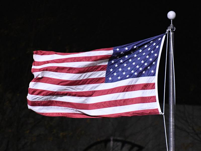 The American flag fly’s in the wind before the start of the Sycamore game on Friday Oct. 27, 2023, during the first week of play offs as they take on Evergreen Park in Sycamore.