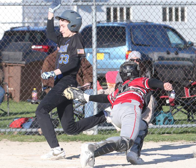 Somonauk's Silas Johnson is called safe at the plate as Earlville catcher Joe Clifford misses the tag on Friday, April 12, 2024 at Earlville High School.