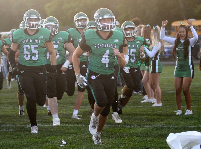 Seneca's Nick Grant (4) leads the football team onto the field for their home game against Lisle on Friday, Sept. 6, 2024.