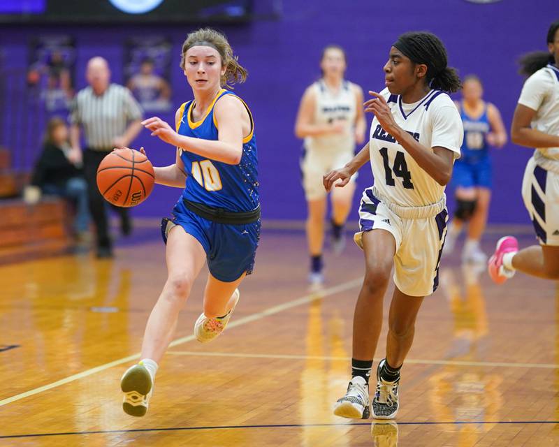 Johnsburg's Wynne Oeffling (10) drives to the basket against Plano's Luniah Gilford (14) during a basketball game at Plano High School on Tuesday, Jan 30, 2024.