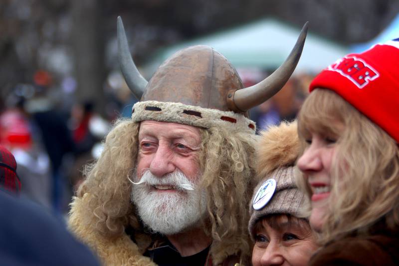 Marty “The Viking” Knapp of Fox River Grove takes pictures with others during the 119th Norge Annual Winter Ski Jump Tournament in Fox River Grove Sunday.