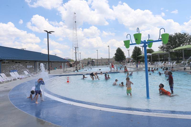 Children cool off in the splash area on Monday, June 17, 2024 at the Riordan Pool in Ottawa.