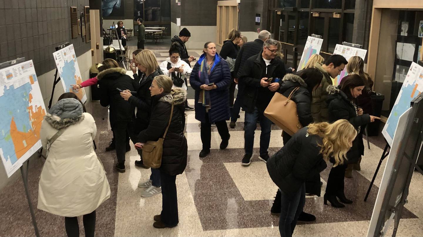 St. Charles School District 303 community members inspect proposed boundary maps at an information session at St. Charles High School on Nov. 28, 2023.