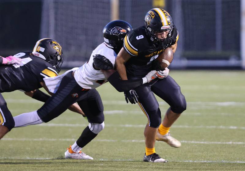 Metea Valley's Nicolas Carrier tries to pull away from DeKalb’s Bryant Debro during their game Friday, Sept 15, 2023, at Metea Valley High School in Aurora.