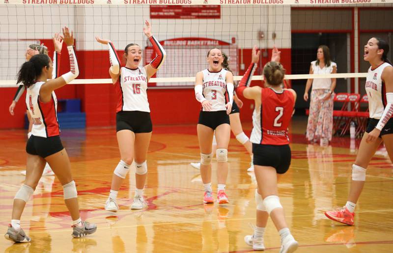 Members of the Streator volleyball team react after defeating Woodland on Monday, Aug. 26, 2024 at Streator High School.