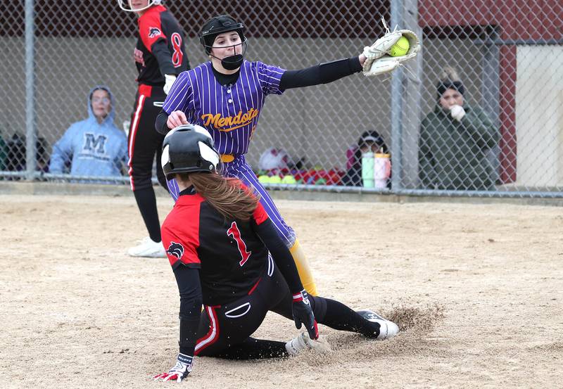 Indian Creek’s Alexandria Edwards scores on a wild pitch as Mendota's Ava Eddy tries to make the tag during their game Thursday, March 14, 2024, at Indian Creek High School in Shabbona.