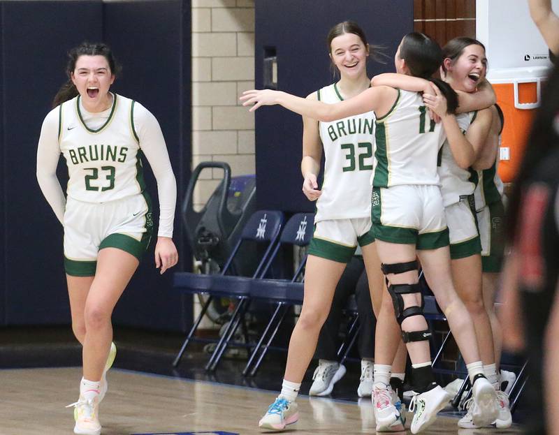 Members of the St. Bede girls basketball team react after defeating Amboy in the Class 1A Regional final game on Friday, Feb. 16, 2024 at Marquette High School.