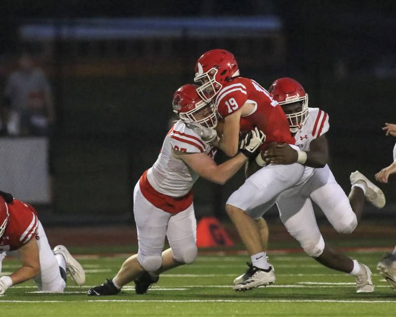 Hinsdale Central's Nicholas Fahy (19) is tackled after a short run during football game between Hinsdale Central vs Naperville Central.  August 27, 2021.  Gary E Duncan Sr. for Shaw Local.