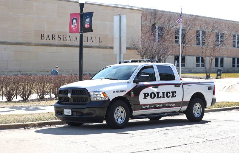 Northern Illinois University Police cars sit outside Barsema Hall Monday, Feb. 26, 2024, after the NIU College of Business received an unverified anonymous email indicating there would be an act of violence committed there today. NIU police Chief Darren Mitchell said as of 10:30 a.m., authorities do not believe the threats to be credible, though the investigation remains ongoing.