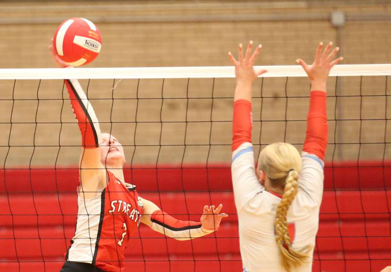 Streator's Emma Rambo spikes the ball past Ottawa's Ella Damron on Thursday, Aug. 29, 2024 in Kingman Gym at Ottawa High School.