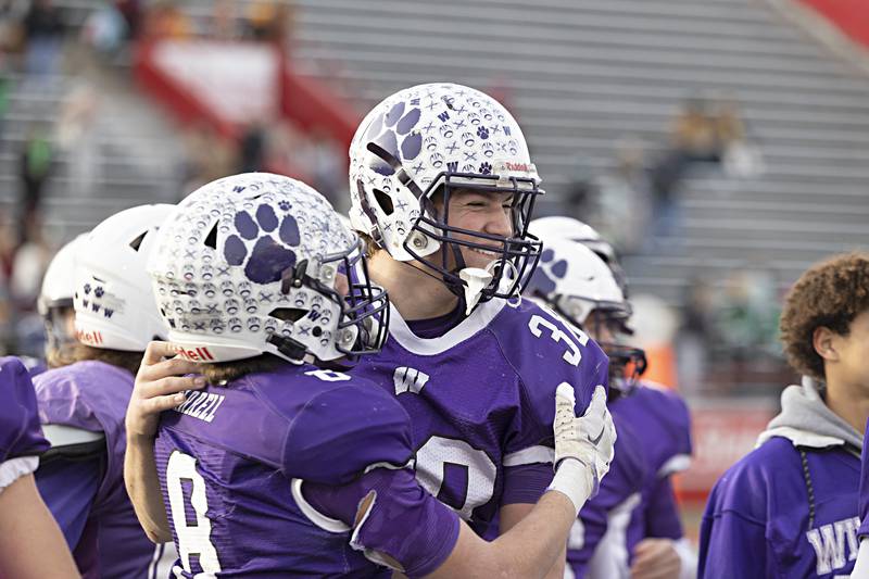 The Wilmington Wildcats celebrate their 28-3 win over Athens Friday, Nov. 24, 2023 in the 2A state football championship game at Hancock Stadium in Normal.