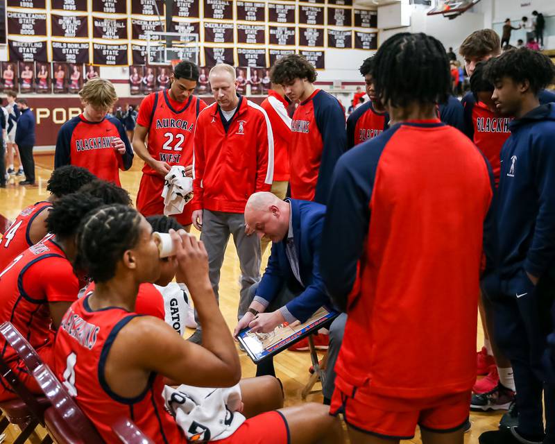 West Aurora's head coach Brian Johnson draws up a play during Class 4A Lockport Regional final game between West Aurora at Oswego East.  Feb 24, 2023.