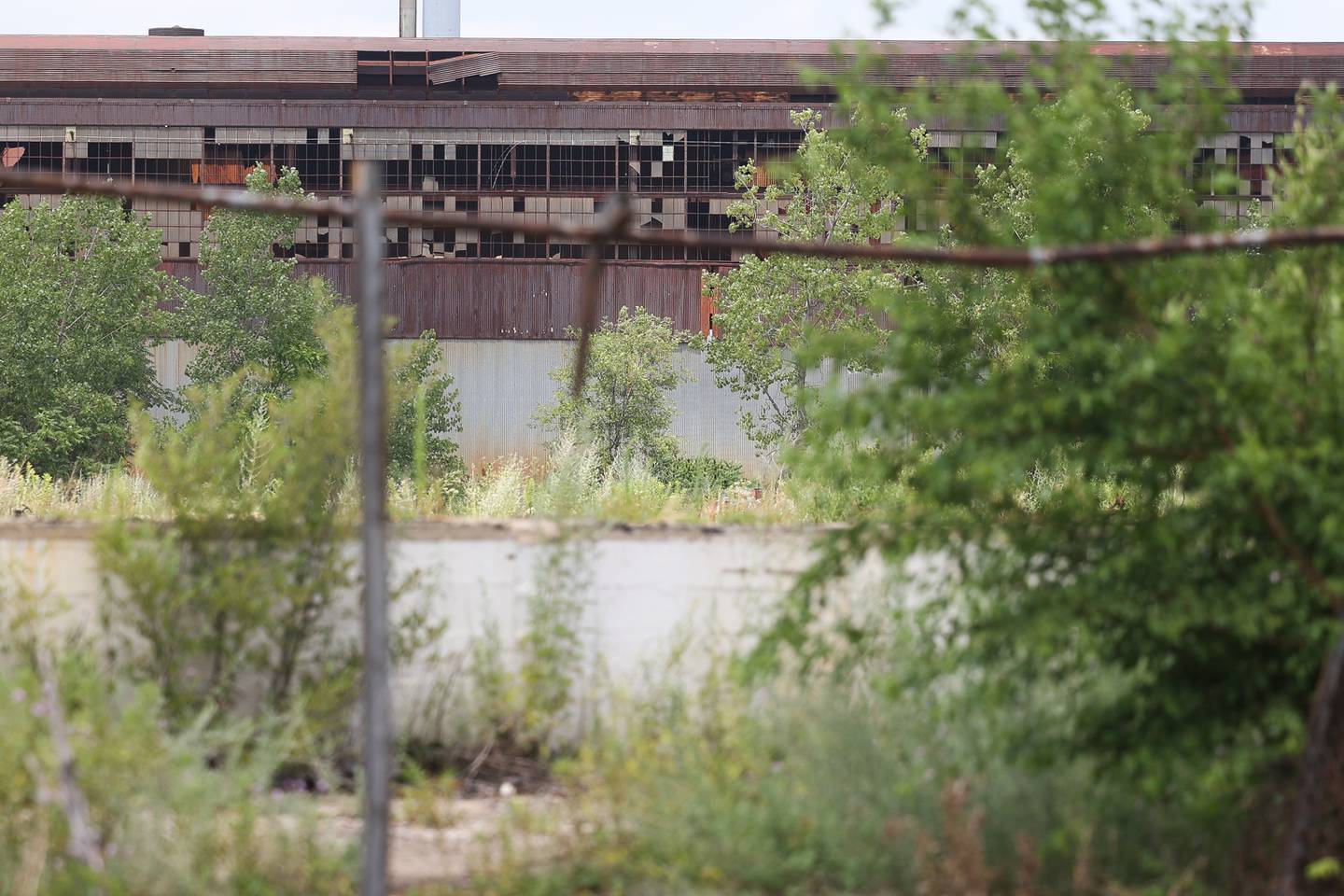 A large section of the chain-link is torn away giving easy access to the abandoned U.S. Steel Mill on Saturday July 13, 2024 in Joliet.