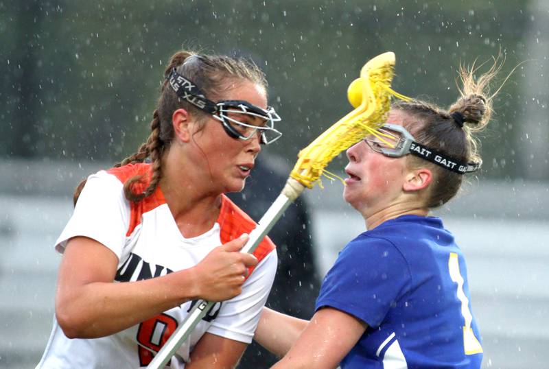 Crystal Lake Central’s Fiona Lemke battles Lake Forest’s Lissy Blume, right, during girls lacrosse supersectional action at Metcalf Field on the campus of Crystal Lake Central Tuesday.