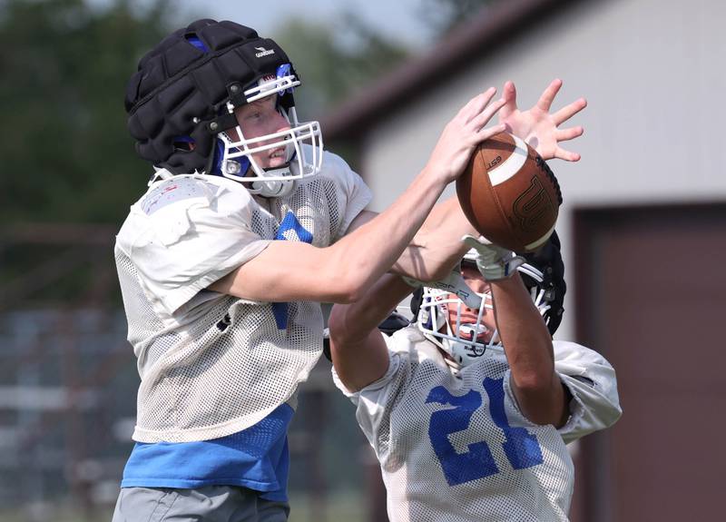 Genoa-Kingston’s Nolan Kline (left) makes an interception during practice Wednesday, Aug. 14, 2024, at the school in Genoa.