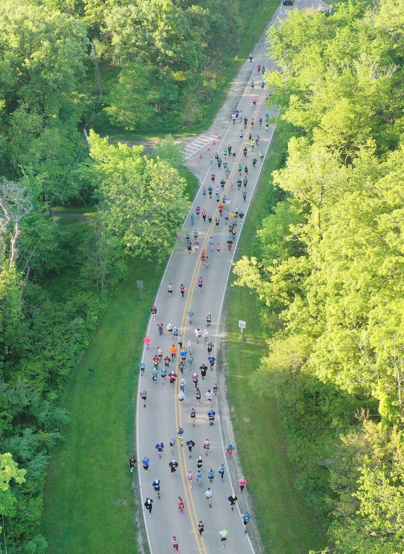 Runners jog through Starve Rock State Park during the Starved Rock Marathon and Half Marathon on Saturday, May 11, 2024.