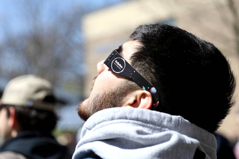Waubonsee Community College student Cesar Garcia looks at the sun using special protective glasses during the solar eclipse on Monday, April 8, 2024 at the college’s Sugar Grove campus.