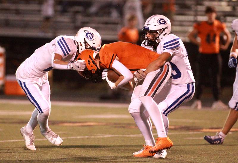 Wheaton Warrenville South’s Luke Beres (center) is surrounded by Geneva’s Dane Turner (left) and Dominic Deleonardi during a game Friday, Sept. 13, 2024 in Wheaton.