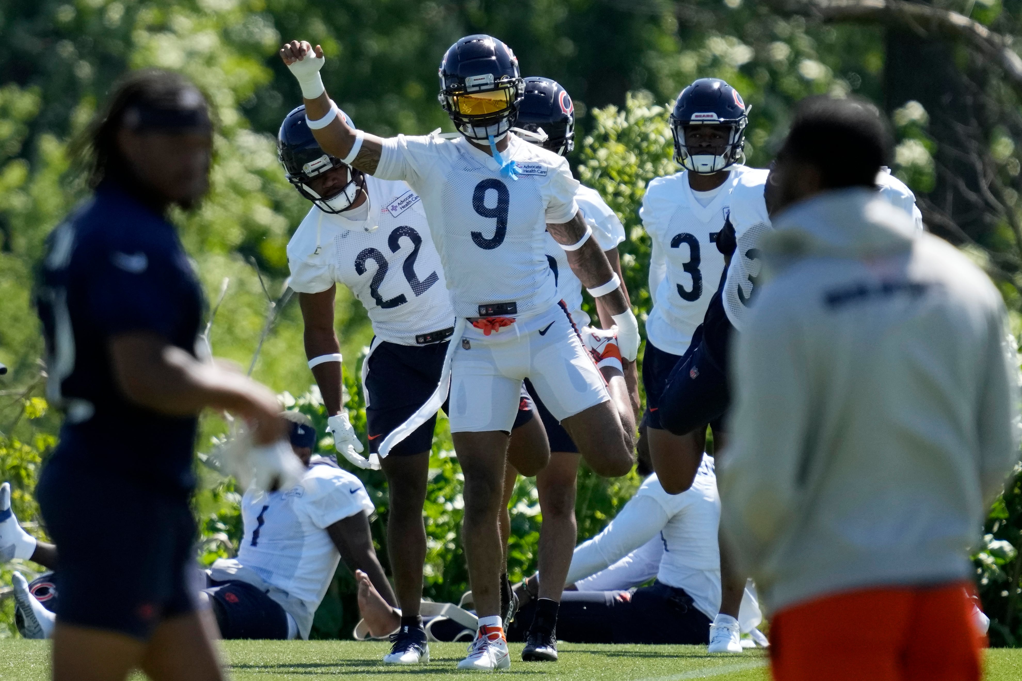 Chicago Bears safety Jaquan Brisker (9) warms up with teammates during the NFL team's mandatory minicamp football practice in Lake Forest, Ill., Thursday, June 6, 2024. (AP Photo/Nam Y. Huh)