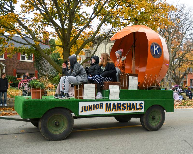 Pumpkin Parade Junior Marshals, picked for their writing contest entries, wave to the parade-goers during the Pumpkin Parade during the final day of the 62nd annual Sycamore Pumpkin Festival Sunday, Oct. 29, 2023.