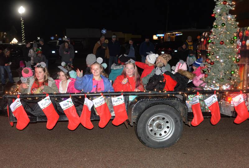 Girl Scouts toss candy from their float in Erie's Hometown Holidays Lighted Parade on Saturday, Dec. 2, 2023.