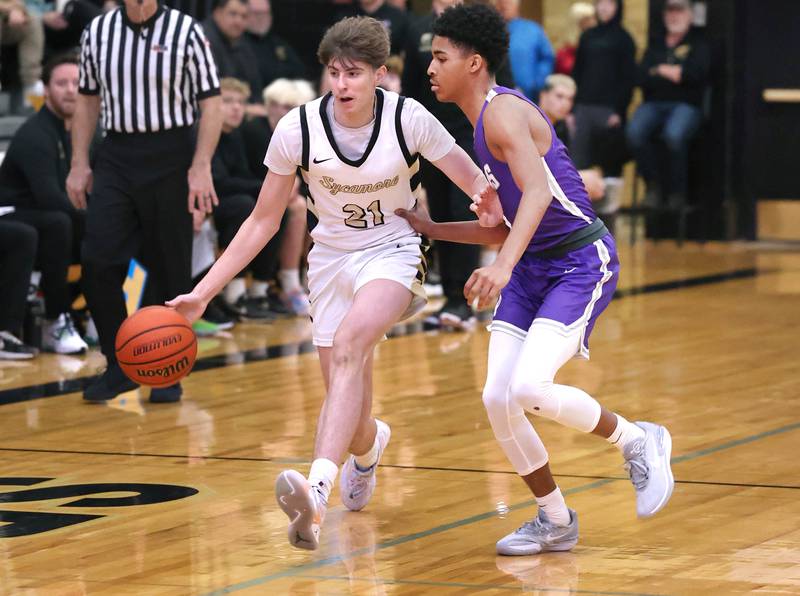 Sycamore's Ben Larry pushes the ball up court against Rochelle's Cayden Moore during their game Tuesday, Dec. 5, 2023, at Sycamore High School.