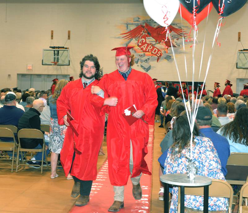 Zac Shuman and Aaron Dallman.have some fun as they link arms while walking out of the gym at the end of Forreston High School's graduation ceremony on Sunday, May 12, 2024.