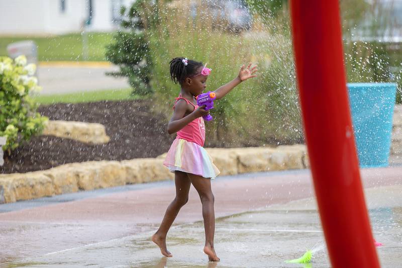 Brooklyn, 5, enjoys the Dixon splash pad at the Meadows Wednesday, July 5, 2023 as a hot and humid day descends on the Sauk Valley.